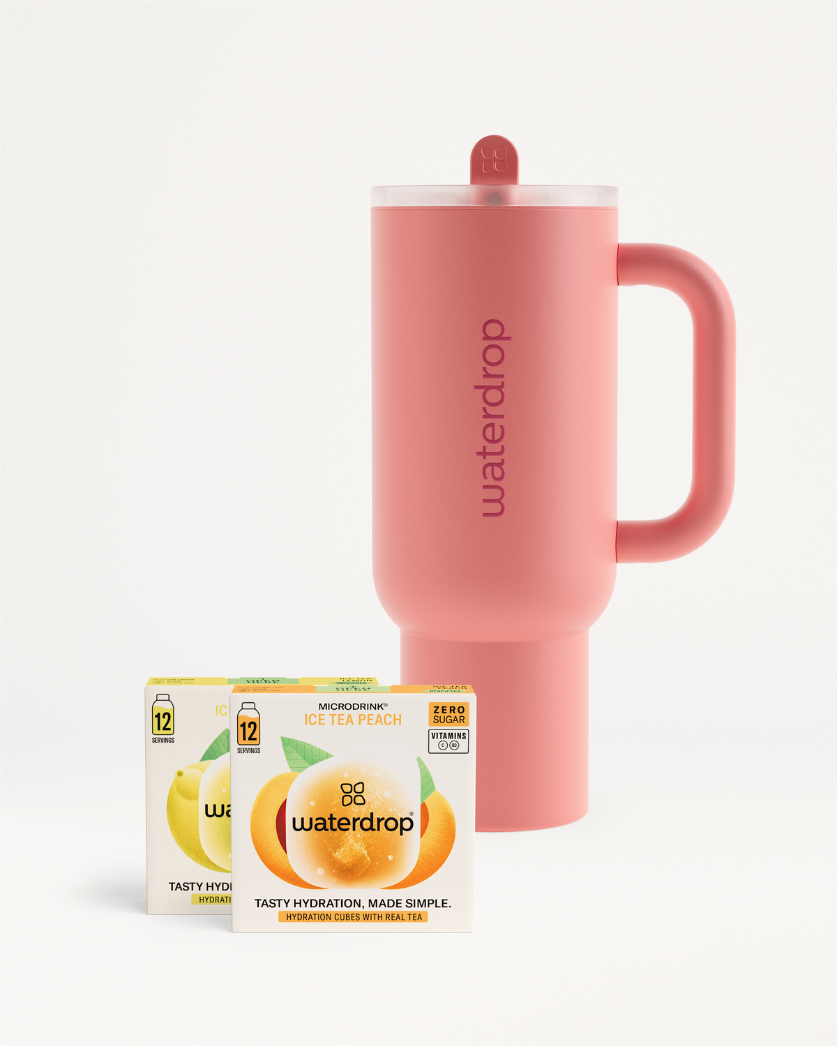 Chill Mode Set: Coral-pink travel mug with matching lid and handle, alongside two boxes of Waterdrop Microdrink cubes, featuring Ice Tea Peach flavor.
