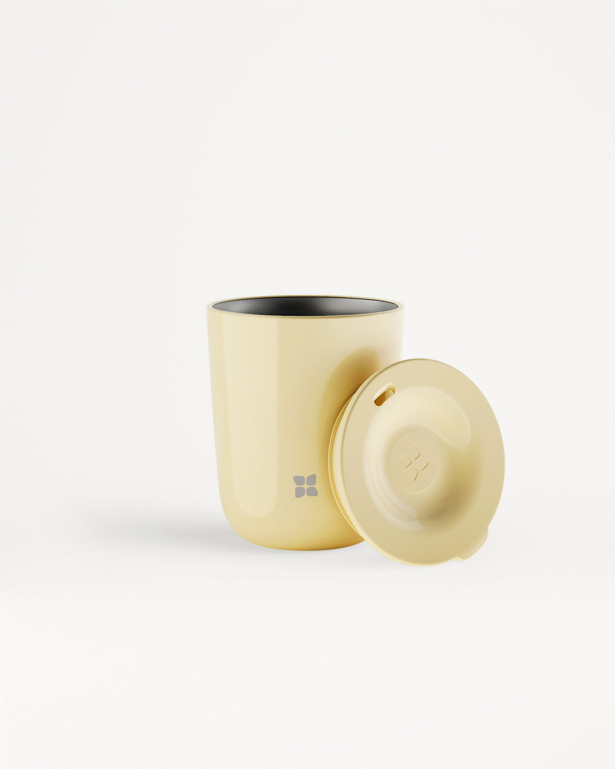 Beige tumbler with a matching beige lid placed beside it.
