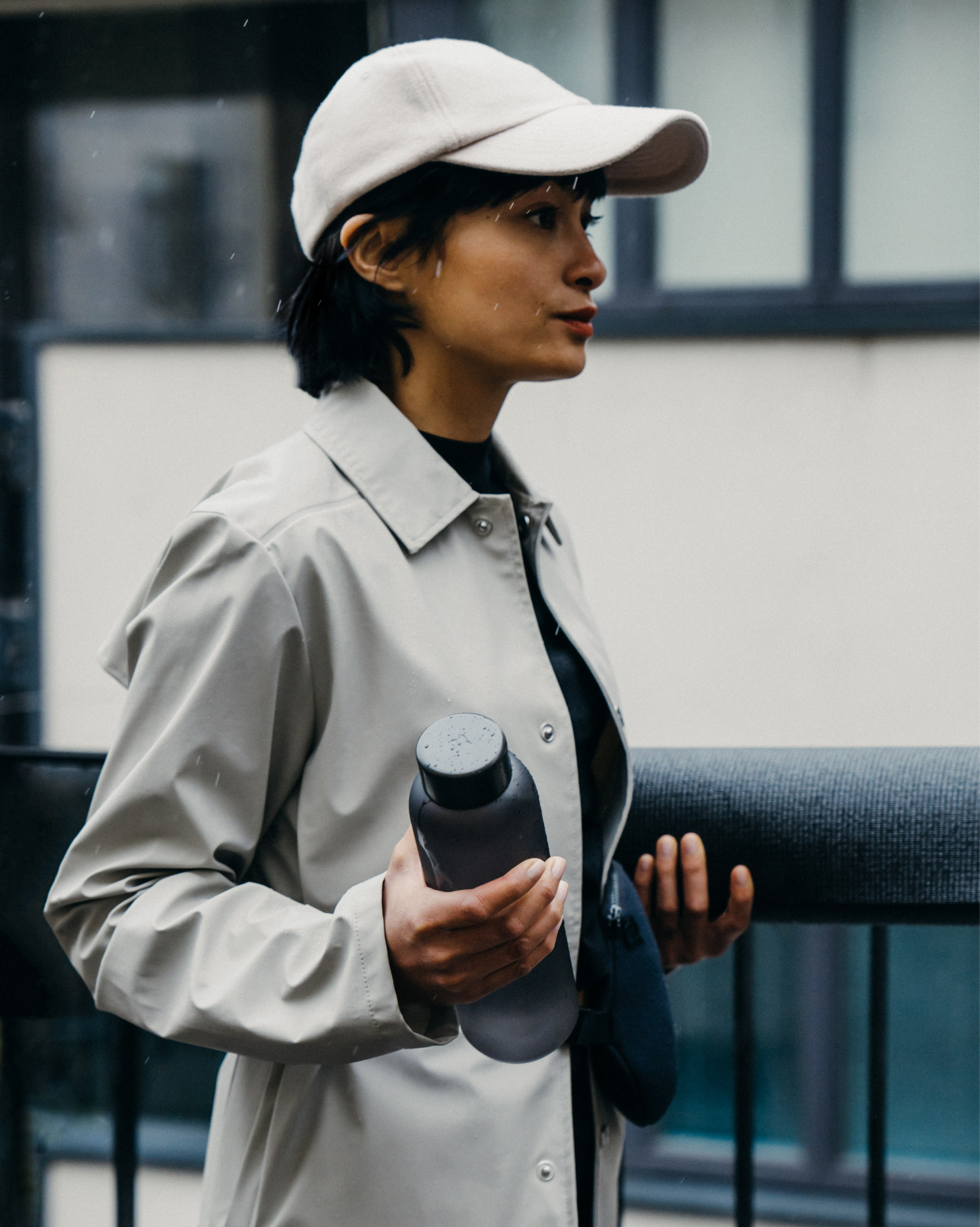 A person holds a Frosted Glass water bottle, showcasing its sleek, frosted design and durable borosilicate glass, perfect for on-the-go hydration.
