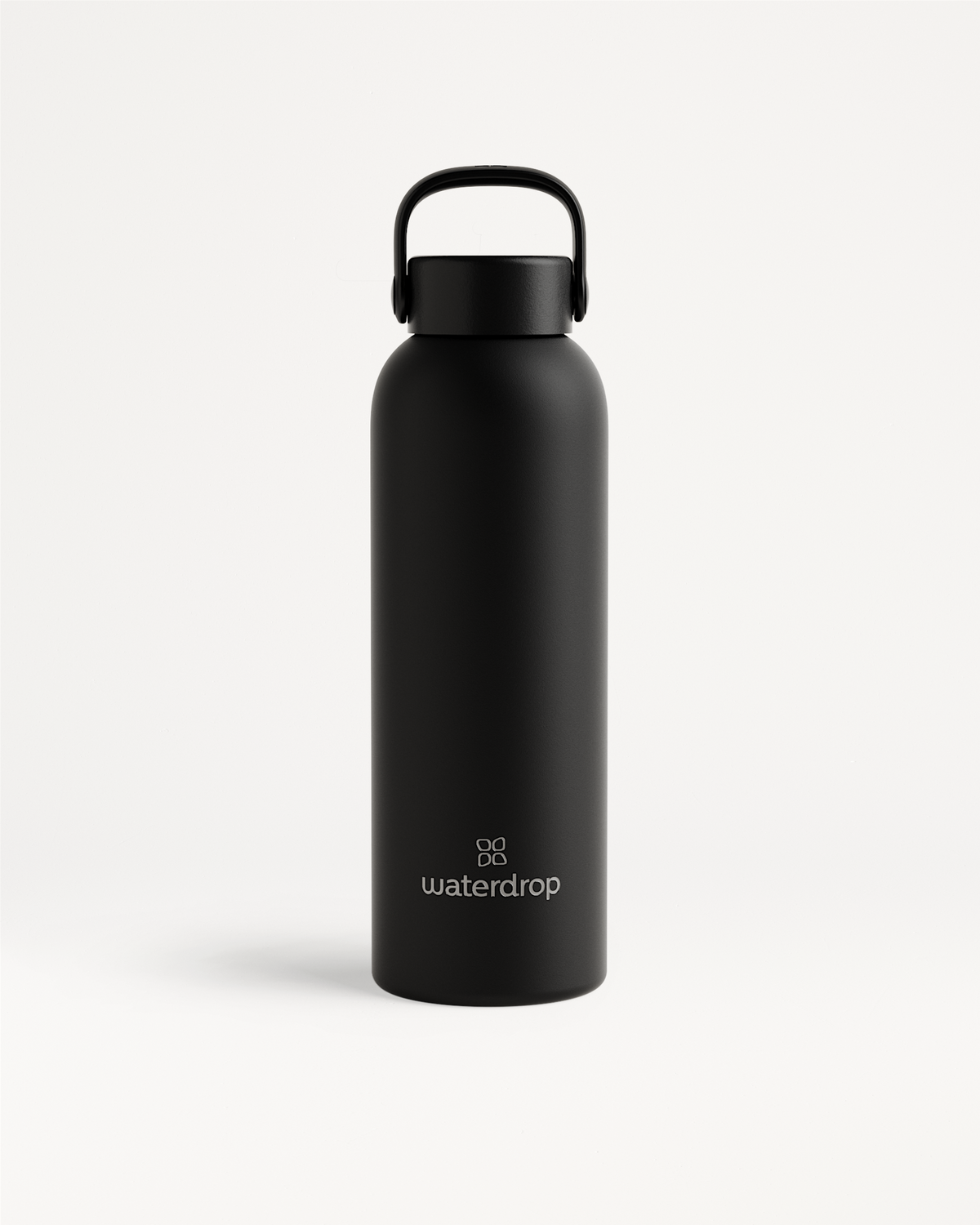 Thermo Steel Bottle · Carry Cap with matte-black finish, rounded cylindrical body, looped handle cap, and waterdrop logo. Available in 600ml or 1L.