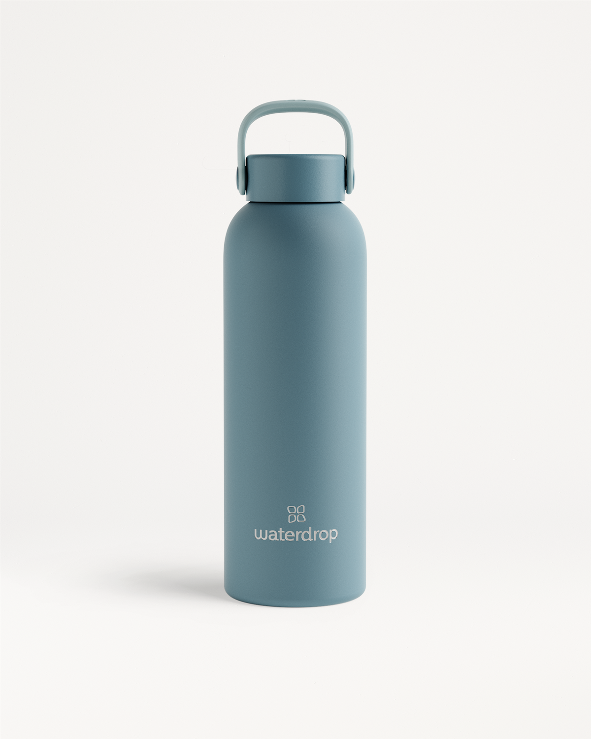 Thermo Steel Bottle · Carry Cap featuring a matte finish, integrated handle, and waterdrop branding. Keeps beverages cold for 24 hours or hot for 12 hours.