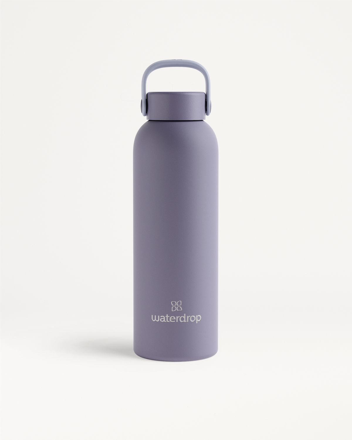 Thermo Steel Bottle · Carry Cap, shown in soft purple, features a matte-finish stainless-steel design with a loop handle, offering 600ml capacity for temperature retention.