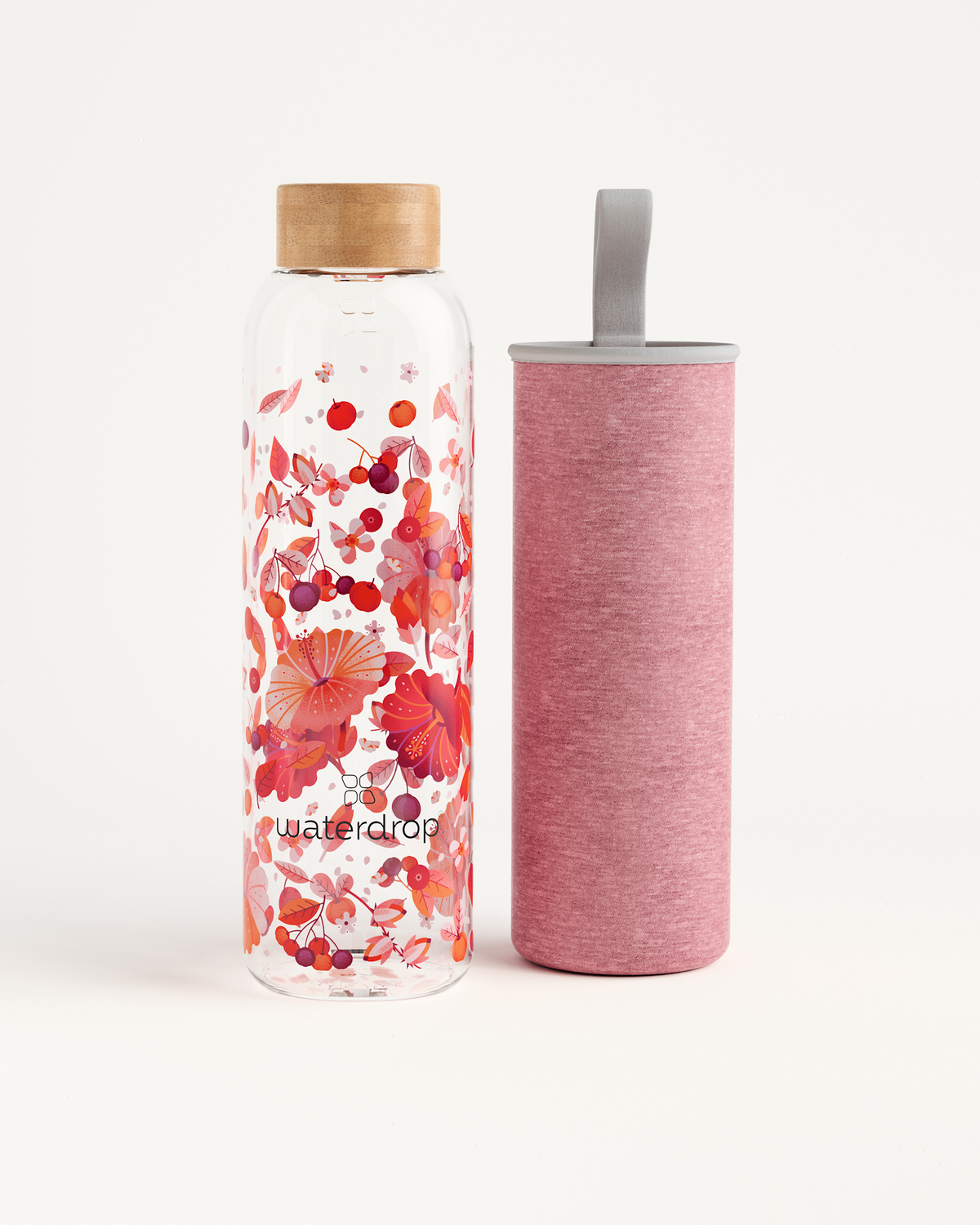 Edition Glass bottle made of robust borosilicate glass shown close-up with floral design ideal for eco-friendly hydration on-the-go. Available in 600ml and 1L sizes.