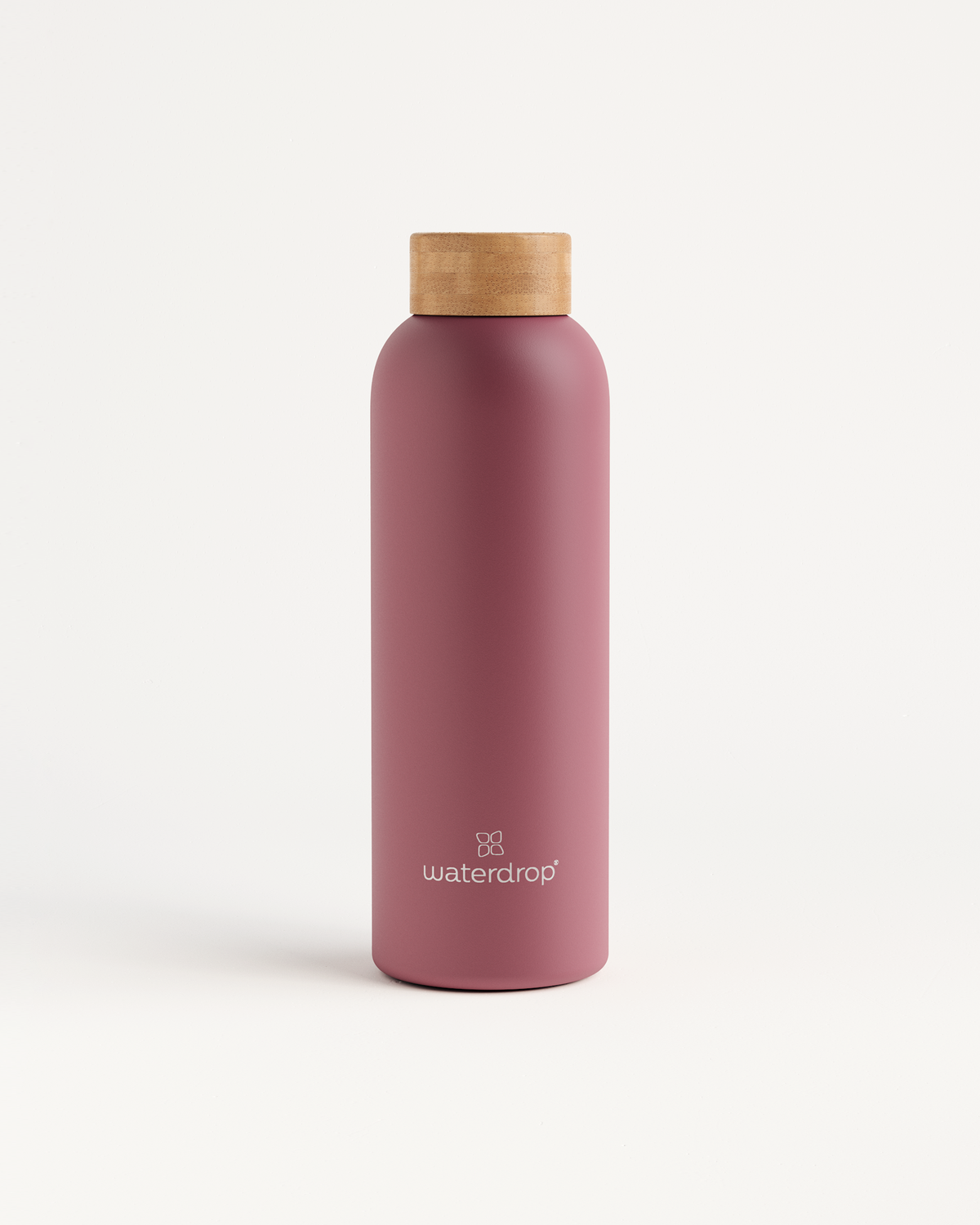 Thermo Steel bottle with a wooden lid, showcasing a sleek cylindrical design, offers temperature retention for drinks in sizes 400ml, 600ml, or 1L.