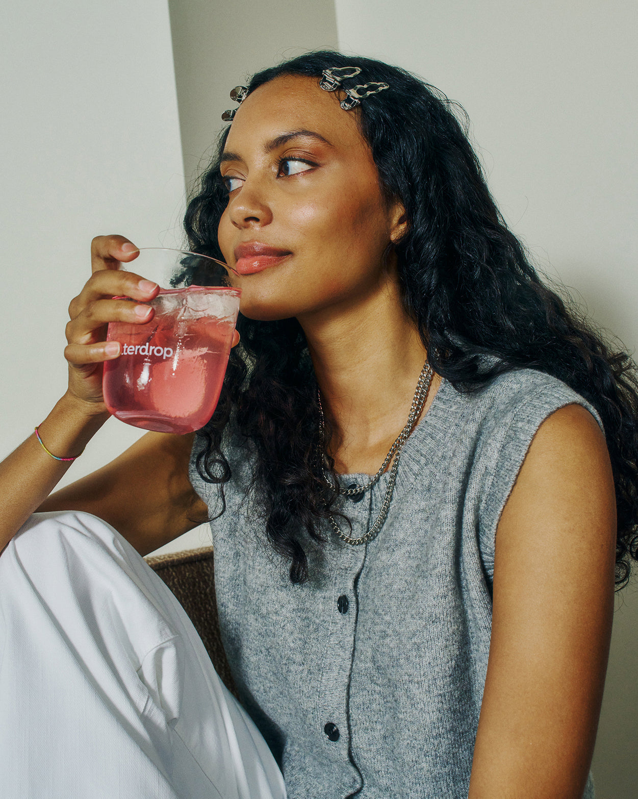 Young woman sipping drink from waterdrop® Advent Calendar Small Twin Pack.