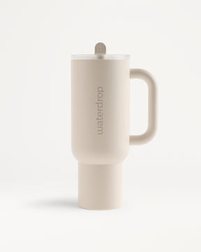 Explorer Thermo Tumbler, a ceramic coffee cup with a handle, designed to keep drinks cold for 12 hours, featuring a convenient flip-open straw.