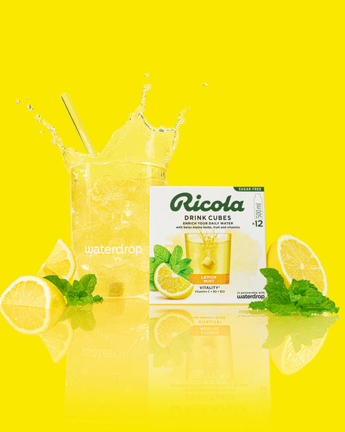 Lemon Mint drink cubes with splash in waterdrop glass.