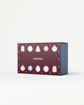 Purple gift box with white holiday icons on the lid and blue interior.