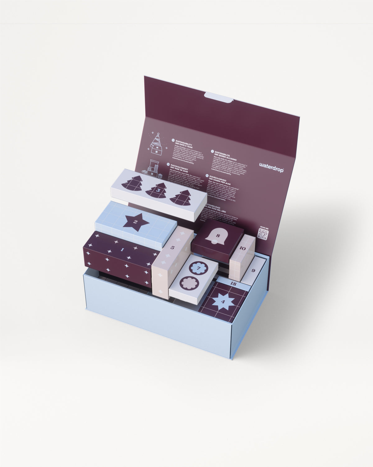 Three-tier light blue gift box with a purple lid opened to reveal several small decorative boxes in coordinating colors.