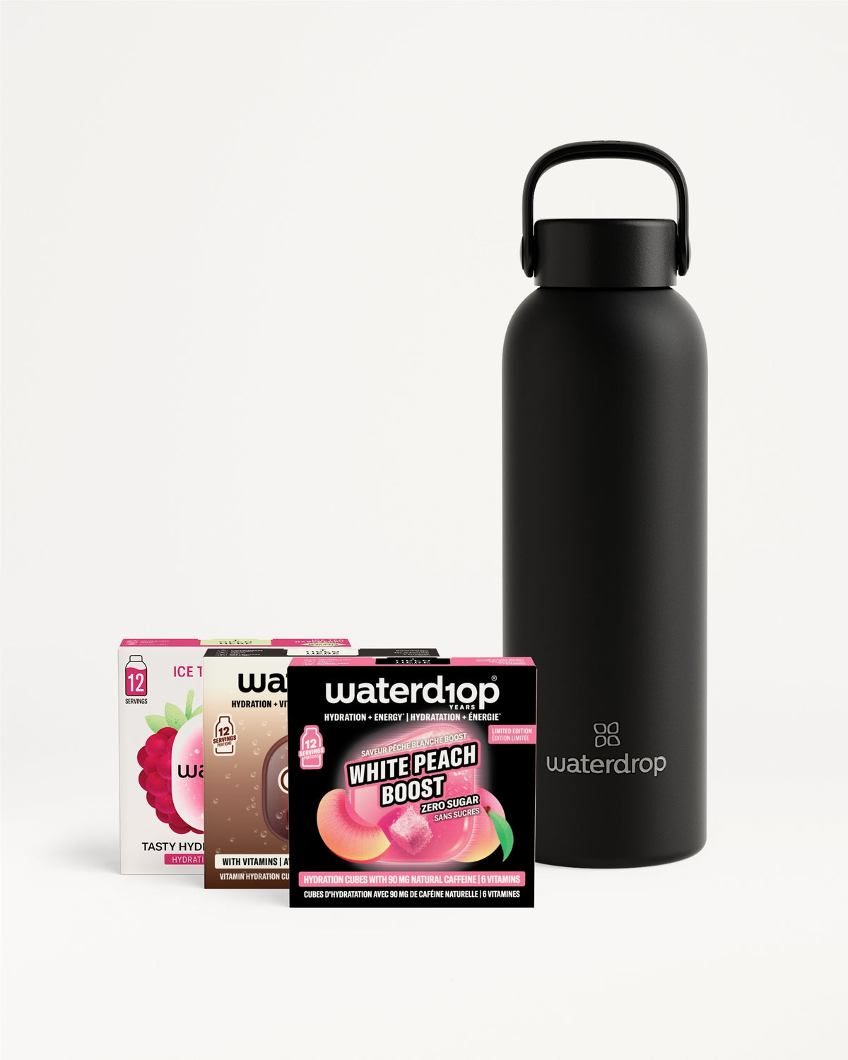 Matte black water bottle with a loop handle beside assorted Waterdrop flavor packets.