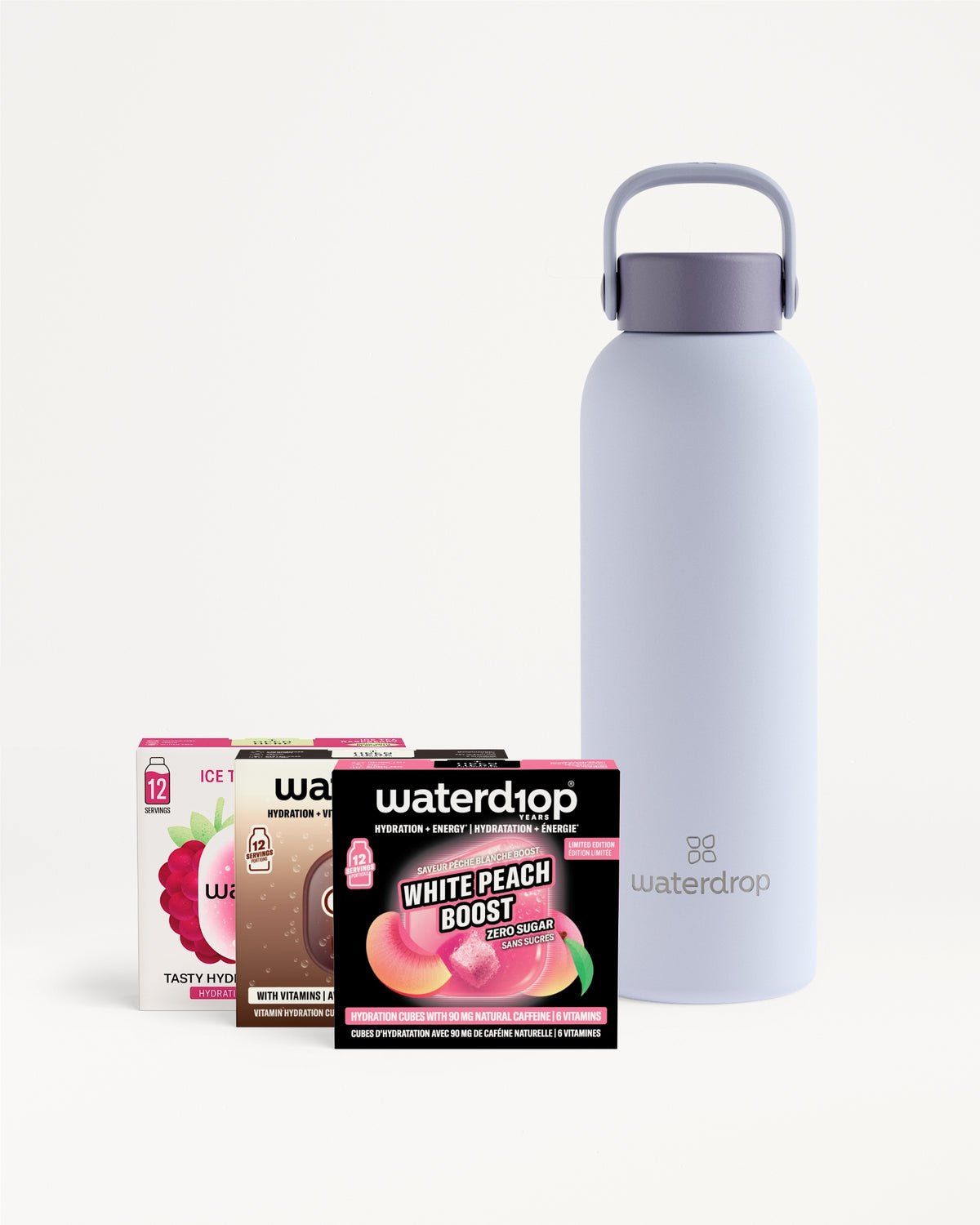 Lavender reusable water bottle with a carry handle beside four flavor sachet boxes.