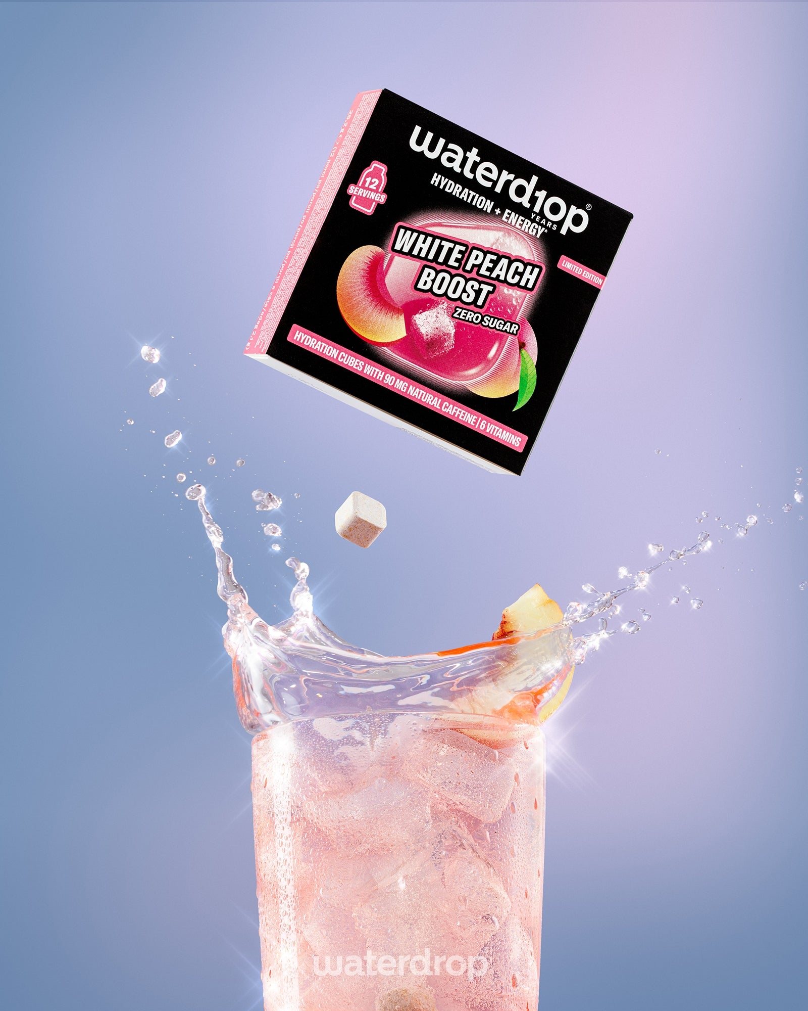 Box of White Peach Boost drink mix suspended above a pink peach-flavored beverage with ice in a tall glass.