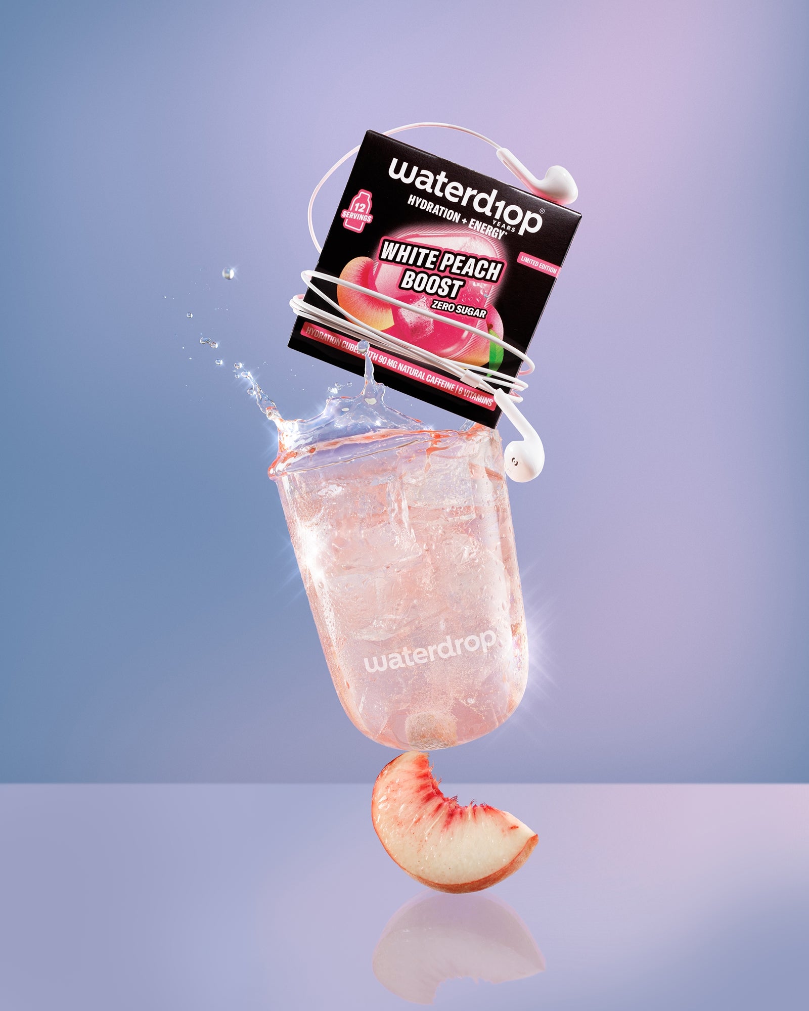 Frozen peach-flavored ice pop suspended above a reflective surface with a peach slice beneath.