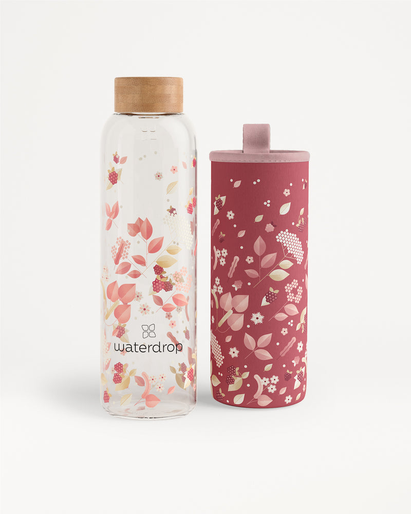 Two floral-patterned water bottles, one clear with a wooden cap and one pink with a matching lid.