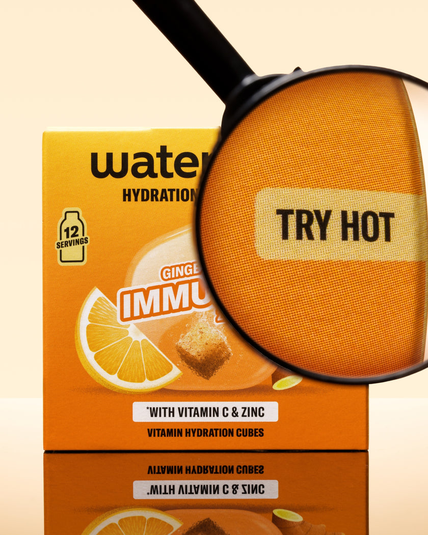 Orange vitamin hydration cubes box with a magnifying glass over an orange cube.