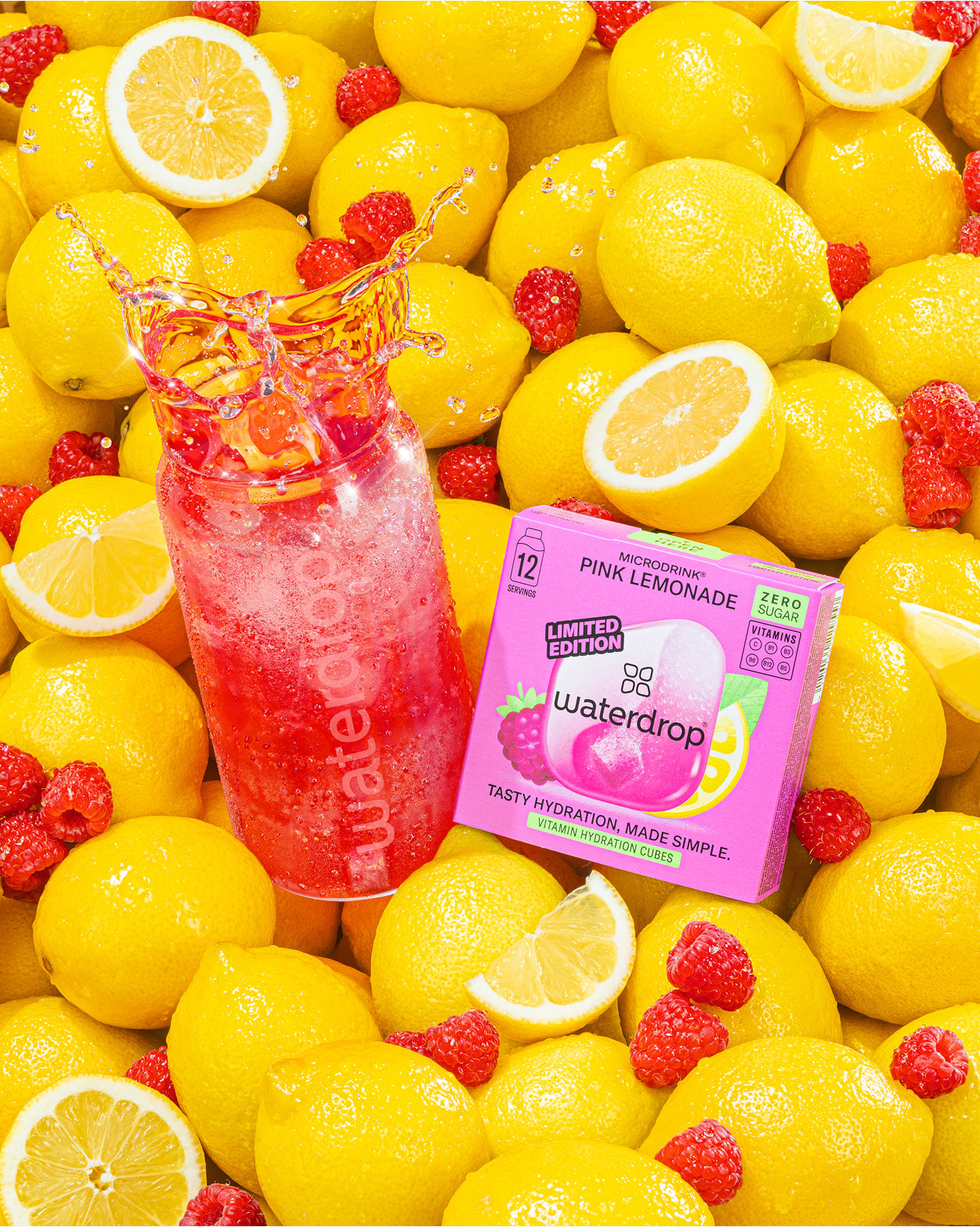 Pink lemonade drink bottle and Waterdrop box among bright lemons.