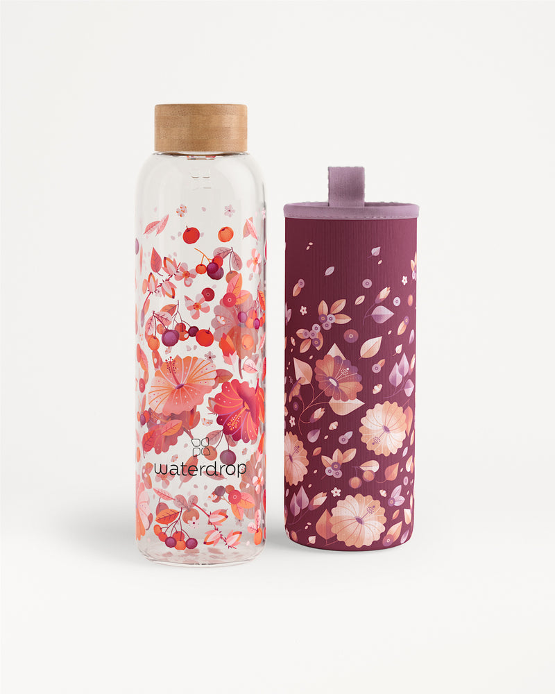 Two floral-patterned water bottles, one clear with a wooden cap and one purple with a floral sleeve.