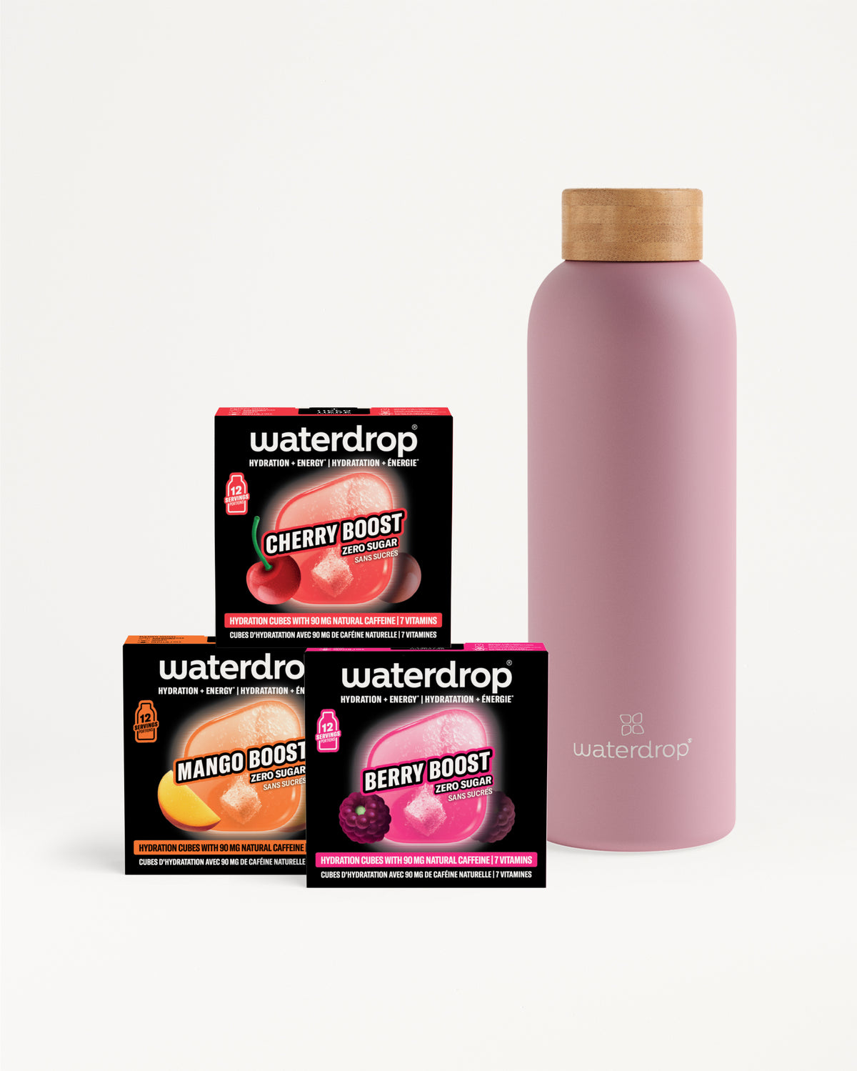 Three flavor-boost boxes and a pink reusable bottle with a wooden cap.