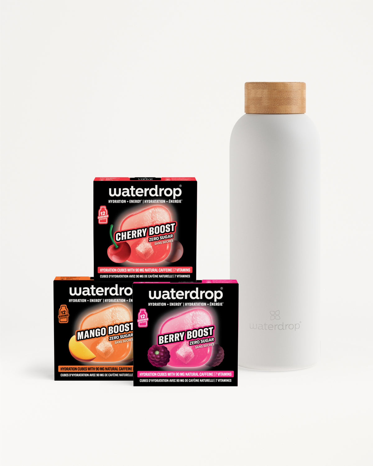 Three Waterdrop flavor boost boxes (cherry, mango, berry) sit beside a white bottle with a wooden cap.