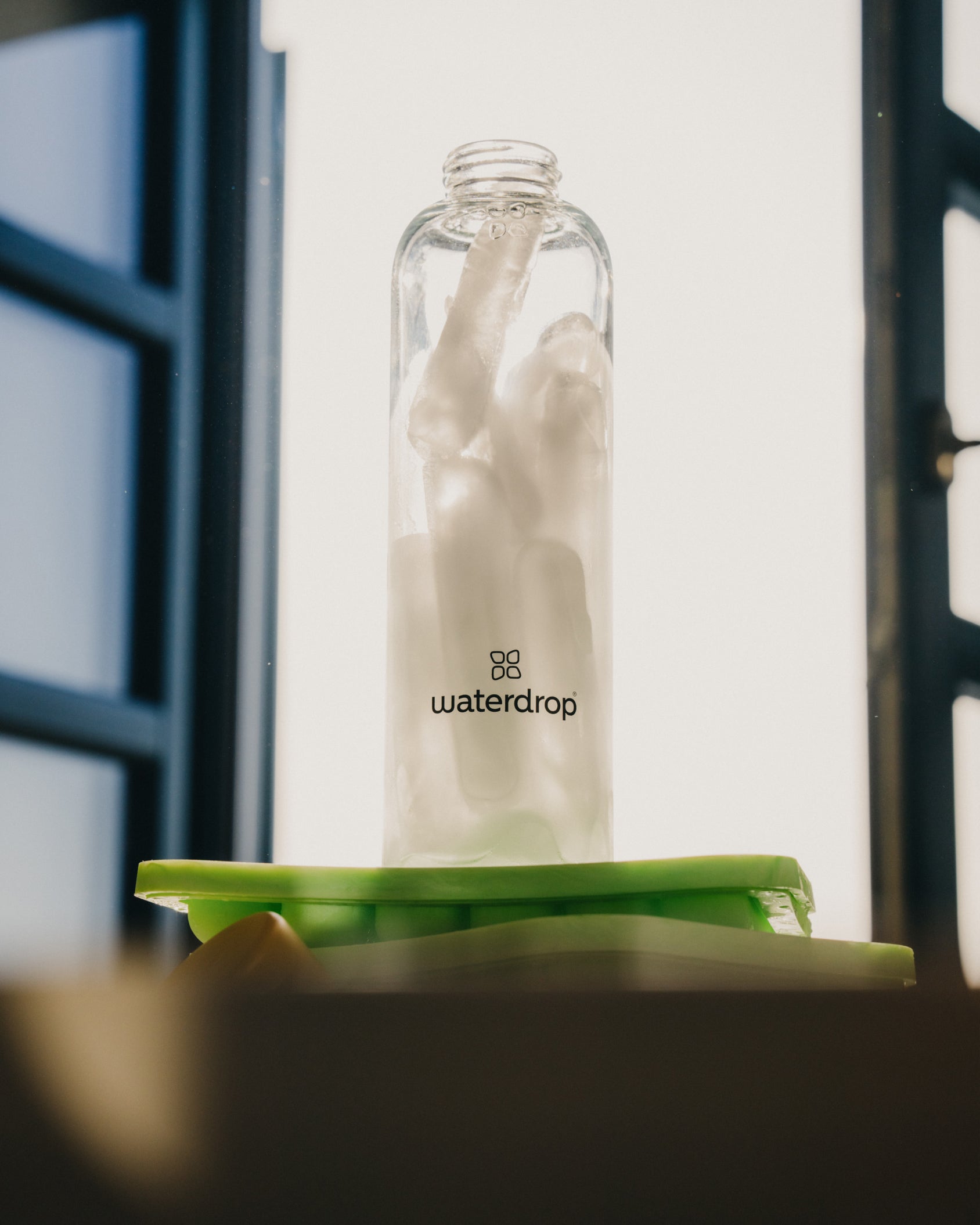 Glass bottle with six ice sticks from the Ice Tray, designed for perfectly chilled Microdrinks.