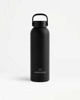 Thermo Steel Bottle · Carry Cap with matte-black finish, rounded cylindrical body, looped handle cap, and waterdrop logo. Available in 600ml or 1L.